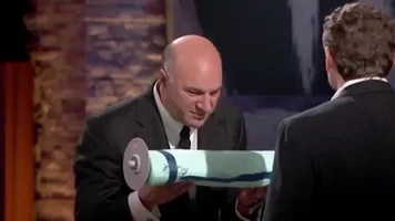 Kevin O’Leary inspecting a sealed BrilliantPad roll on Shark Tank